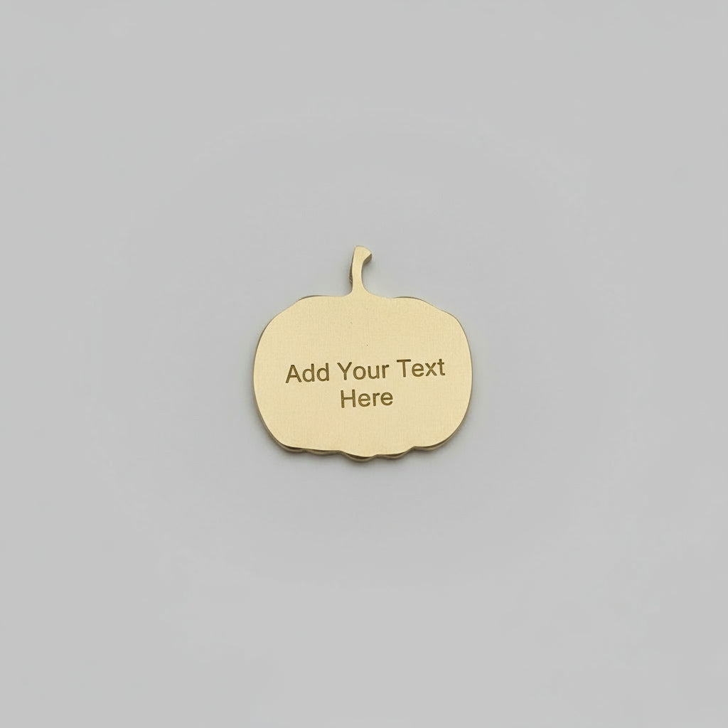 Hand holding a gold-colored metal object against a neutral background