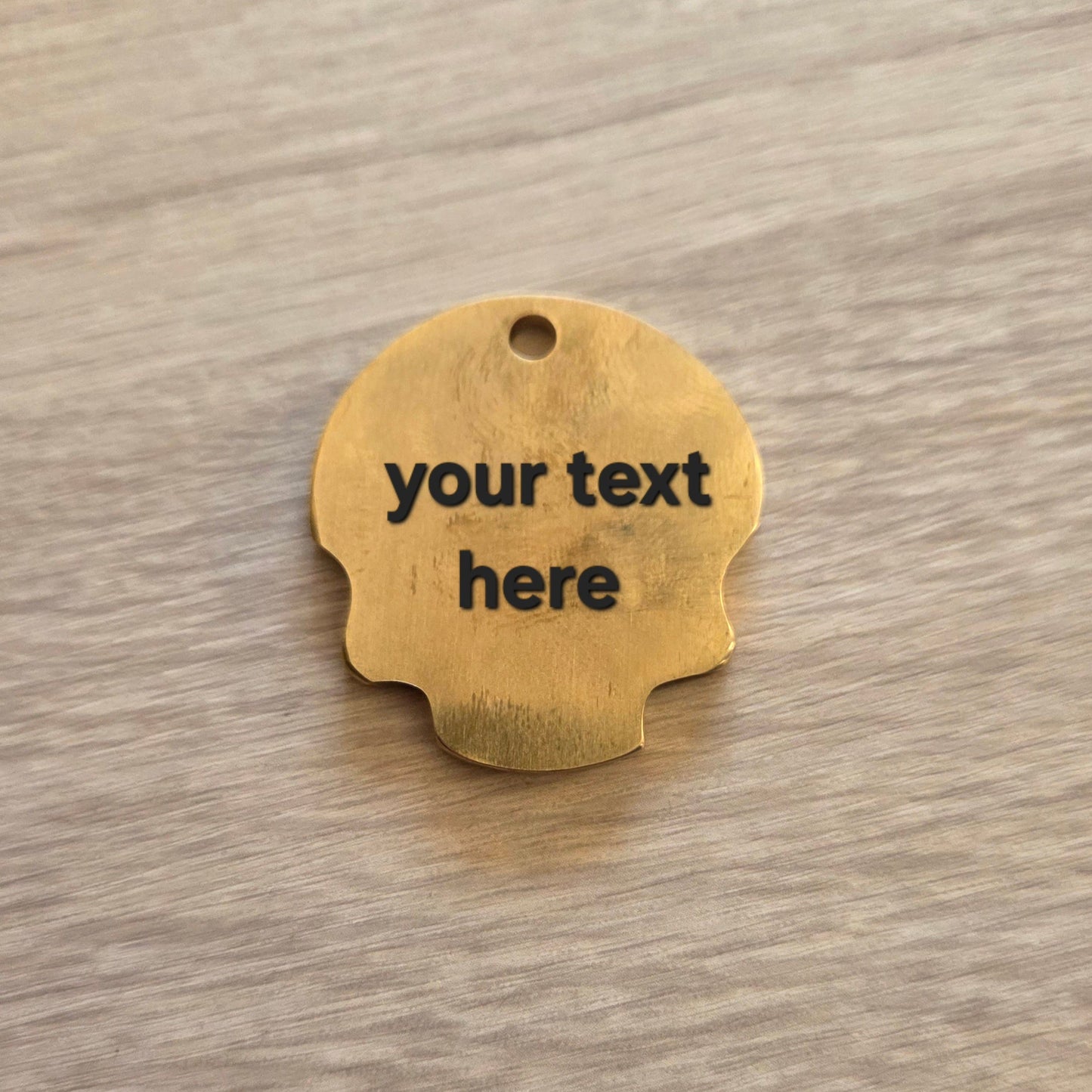 Wooden tag with 'your text here' text on a wooden surface