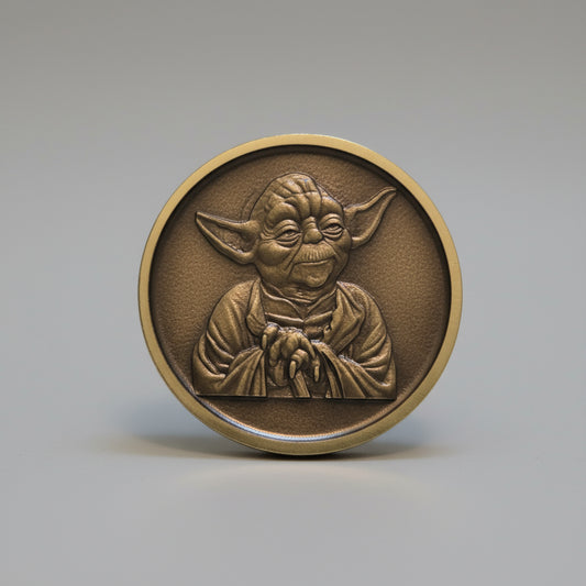 Bronze coin with a design on a wooden surface