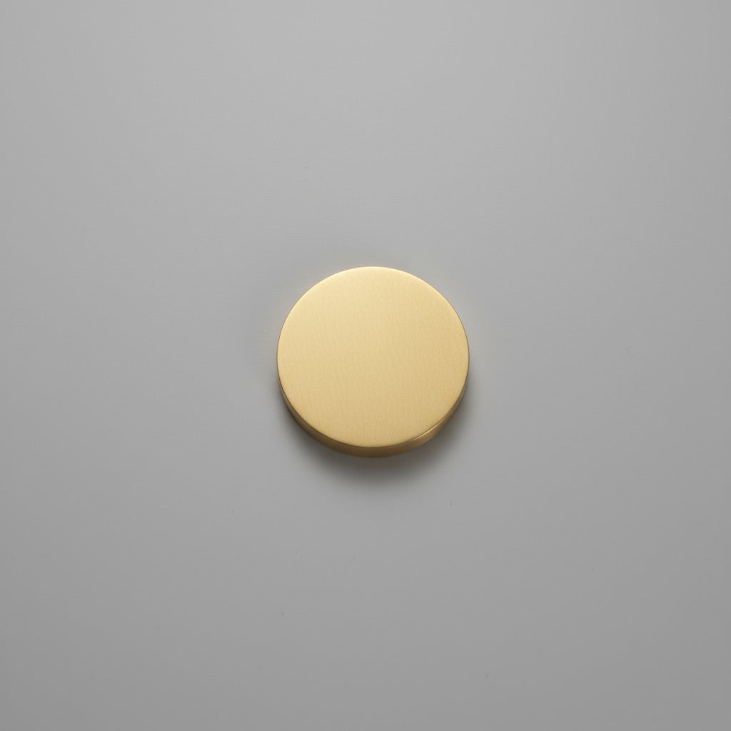 Gold circular object on a gray wooden surface