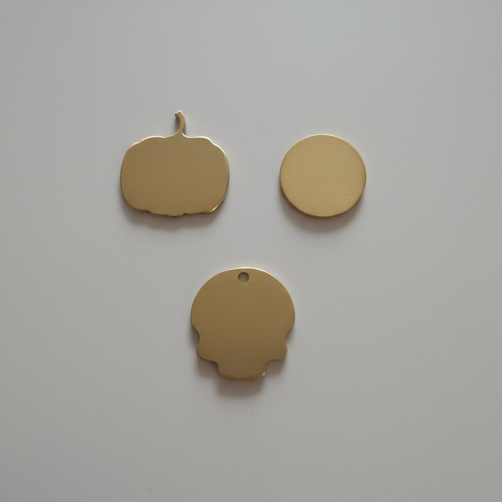 Three gold shapes objects on a wooden surface