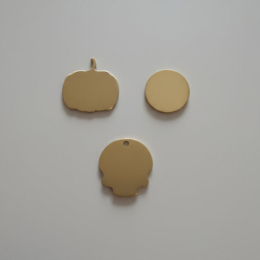 Three gold shapes objects on a wooden surface