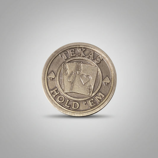 Coin with 'Texas Hold'em' design on a textured gray background