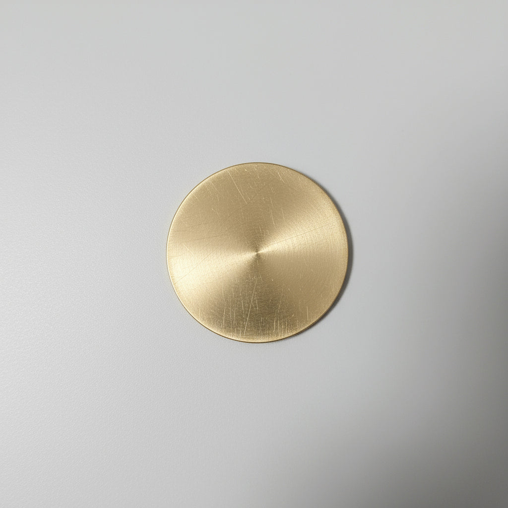 Gold circular object on a textured gray surface