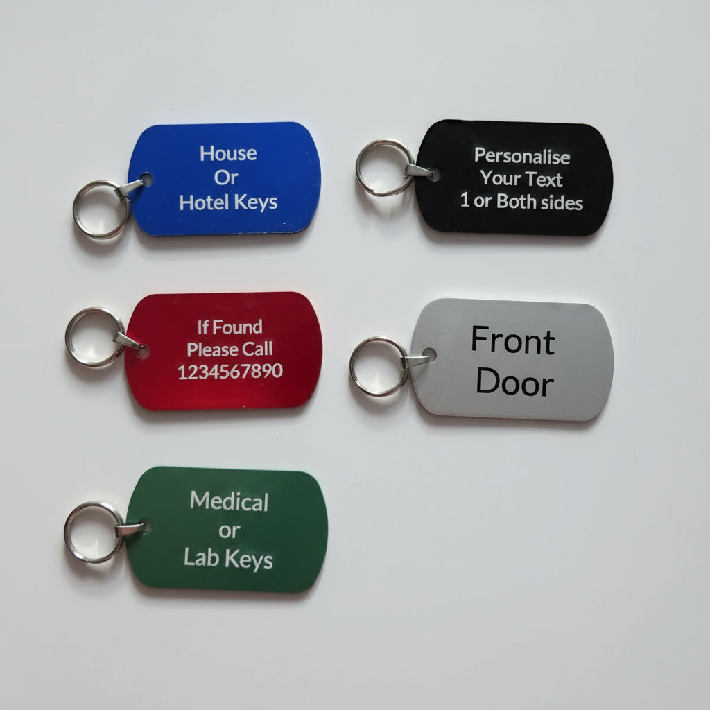 Set of five key tags in different colors with text on a wooden surface