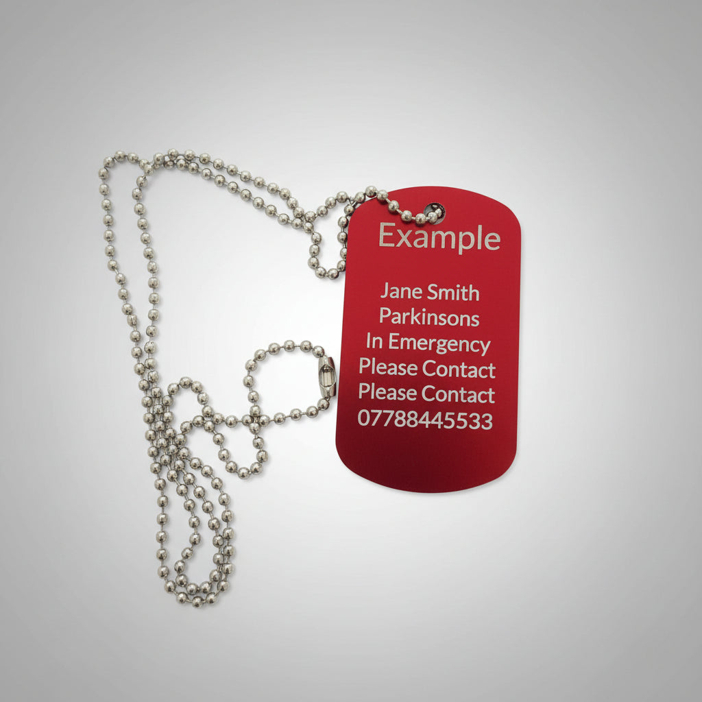 Red tag with silver chain on a light wooden surface
