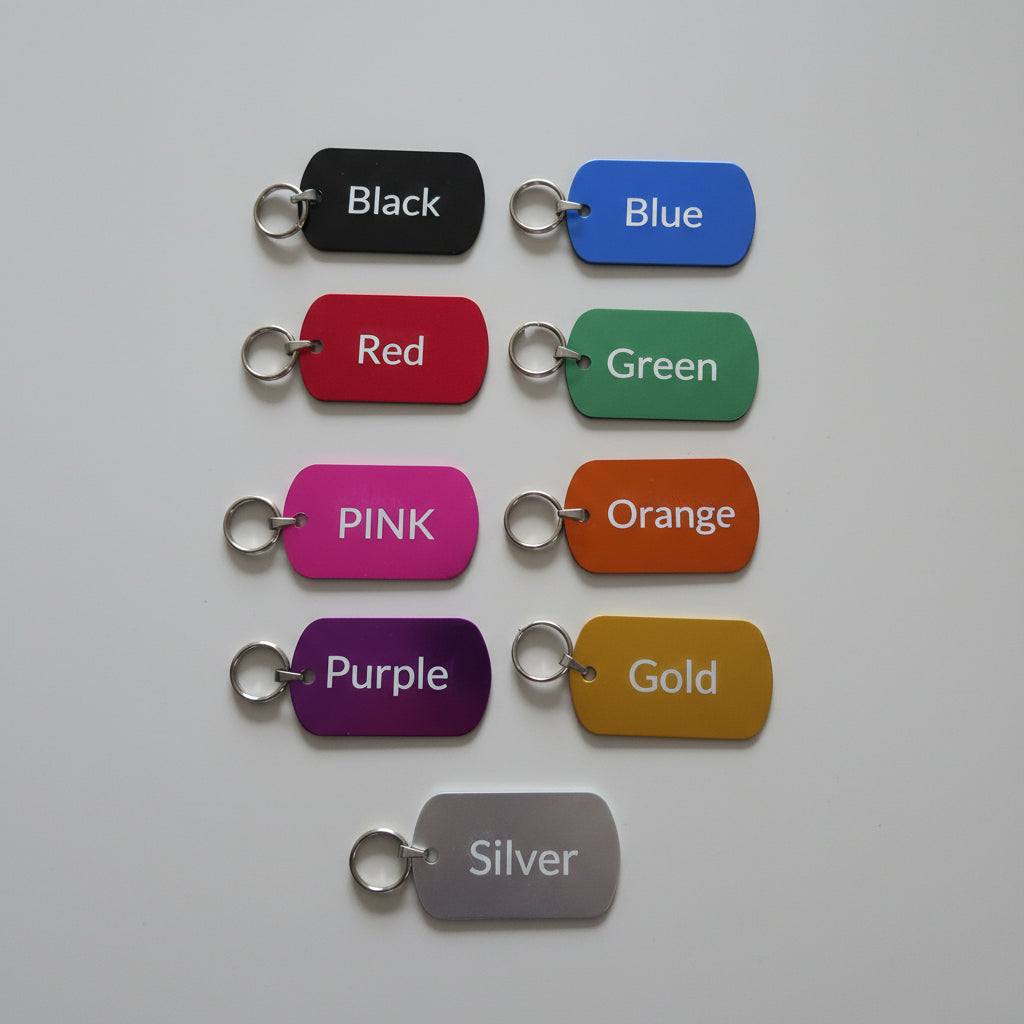 Colorful dog tags labeled with colors on a gray surface