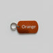 Orange key tag with 'Orange' text on a gray surface