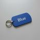 Blue tag with 'Blue' text on a gray surface