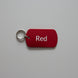 Red key tag with 'Red' text on a gray surface