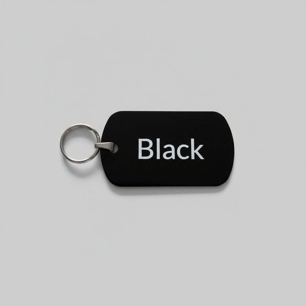 Black dog tag with 'Black' text on a gray surface