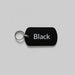 Black dog tag with 'Black' text on a gray surface