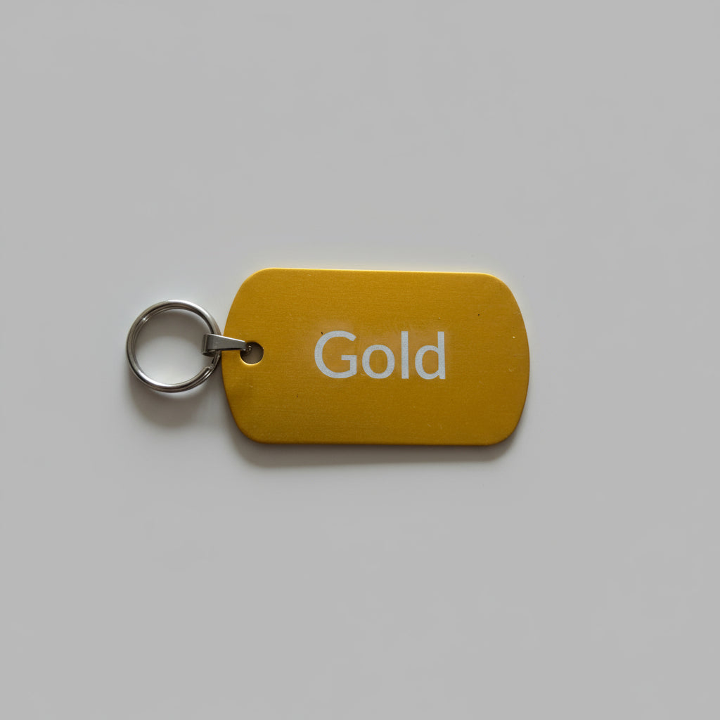 Gold-colored key tag with 'Gold' text on a gray surface