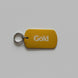 Gold-colored key tag with 'Gold' text on a gray surface