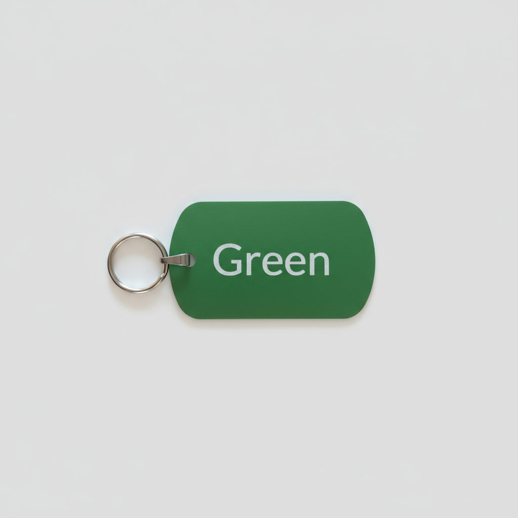 Green tag with 'Green' text and a key ring on a gray wooden surface