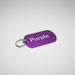 Purple key tag with 'Purple' text on a light wooden surface