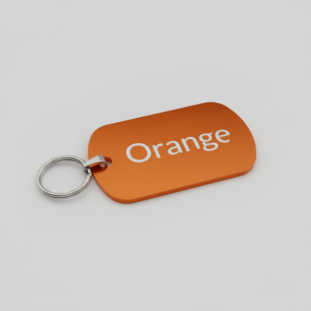 Orange key tag with 'Orange' text on a light wooden surface