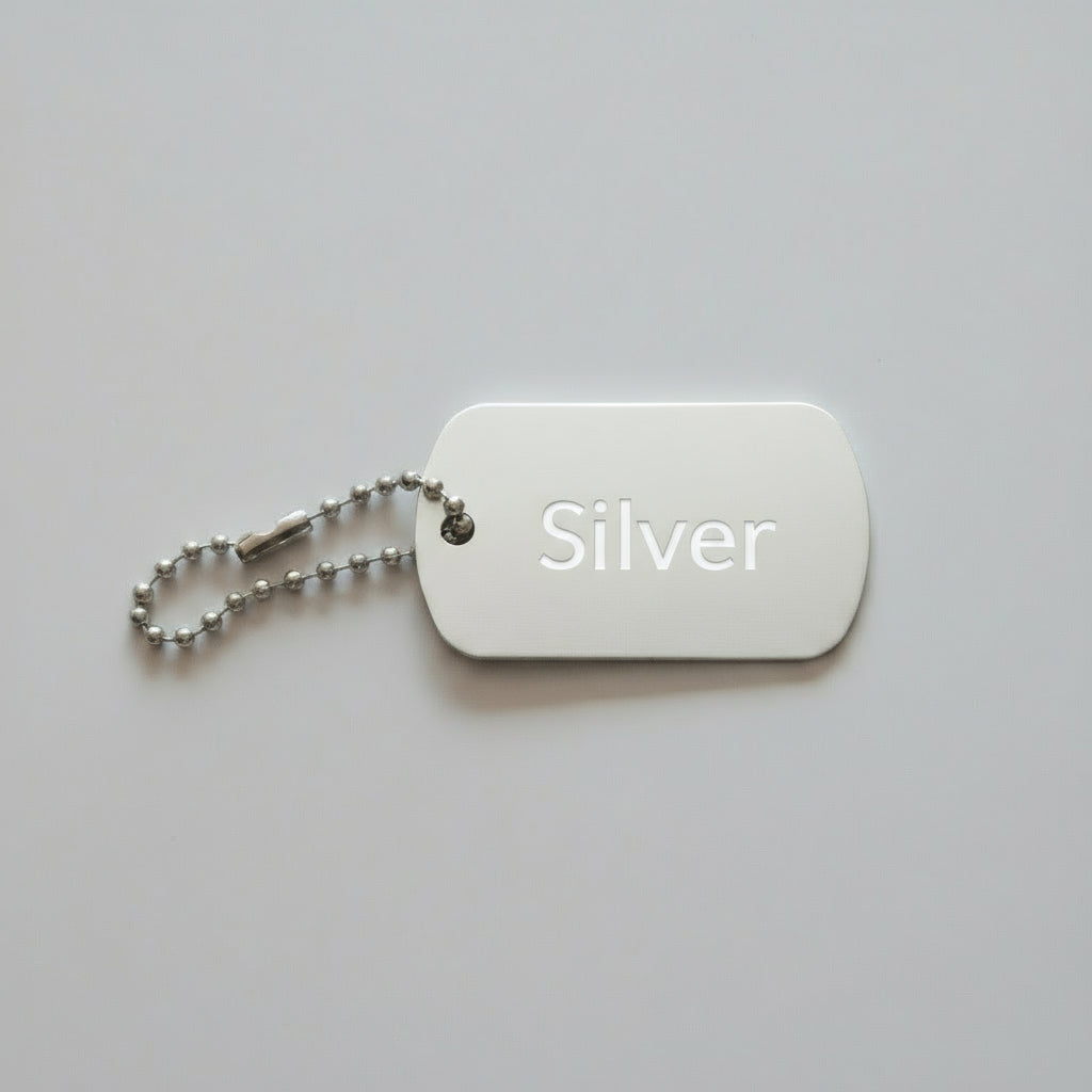 Silver dog tag with chain on a light wooden surface