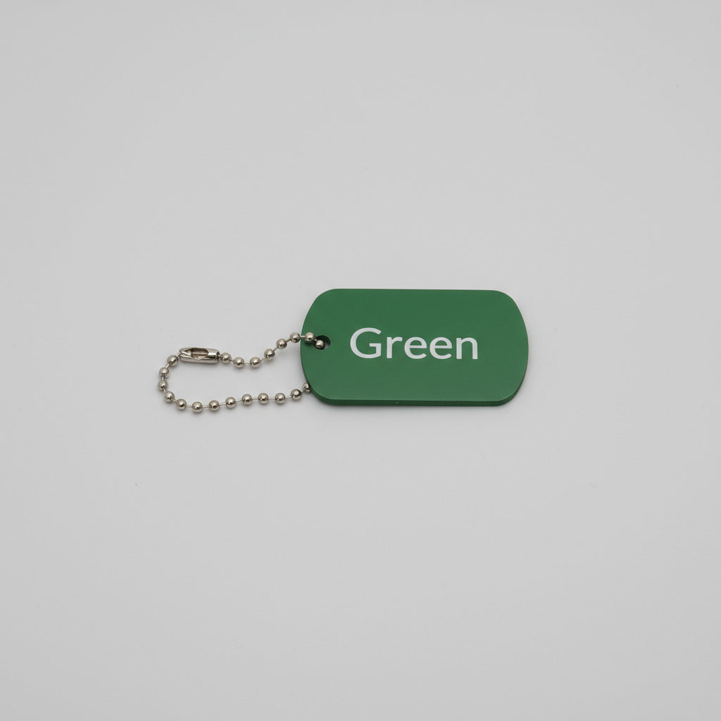 Green tag with 'Green' text and a chain on a gray surface