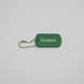 Green tag with 'Green' text and a chain on a gray surface