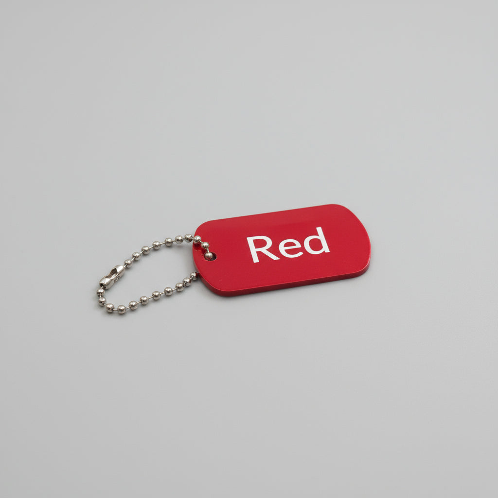 Red keychain tag with 'Red' text on a light wooden surface