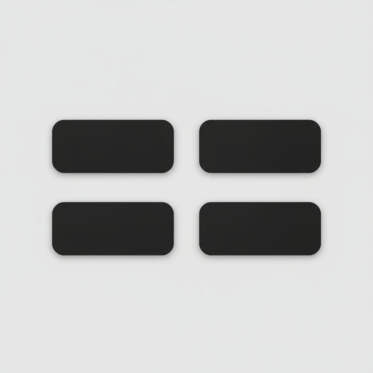 Four black rectangular phone cases on a light wooden surface