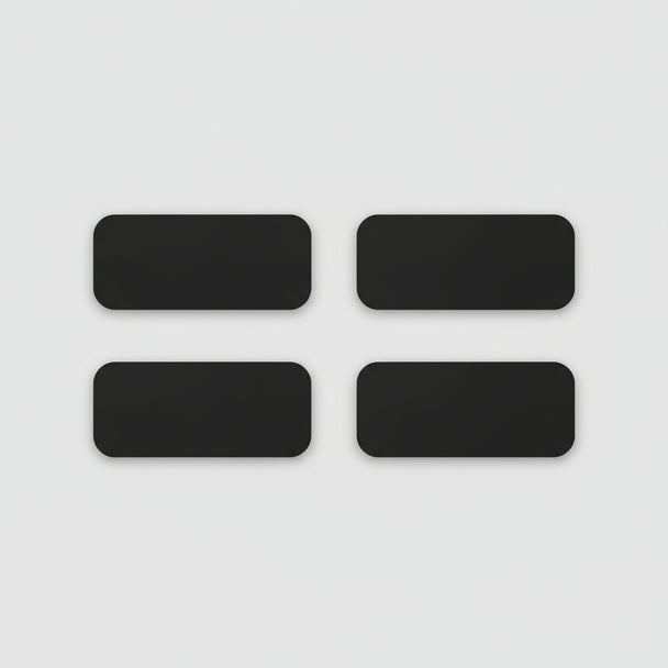 Four black rectangular phone cases on a light wooden surface