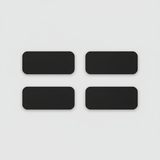 Four black rectangular phone cases on a light wooden surface