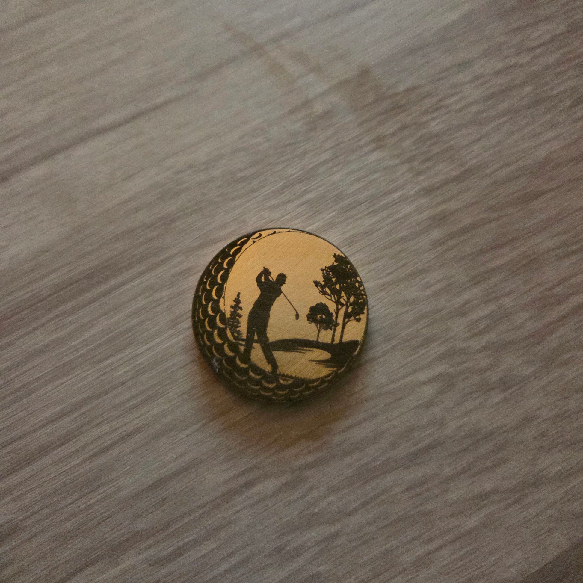 Round wooden object with carvings on a wooden surface