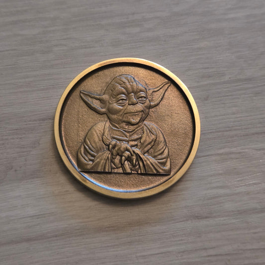 Bronze coin with a design on a wooden surface