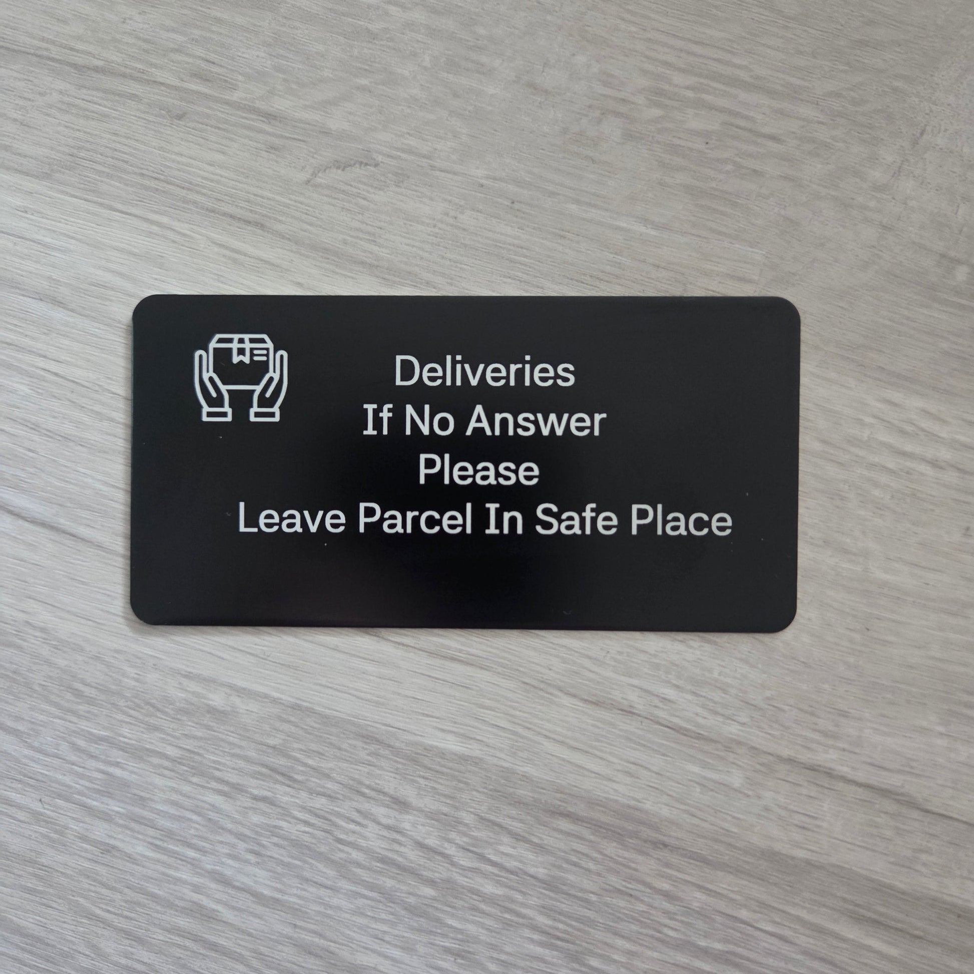 Black card with white text on a wooden surface