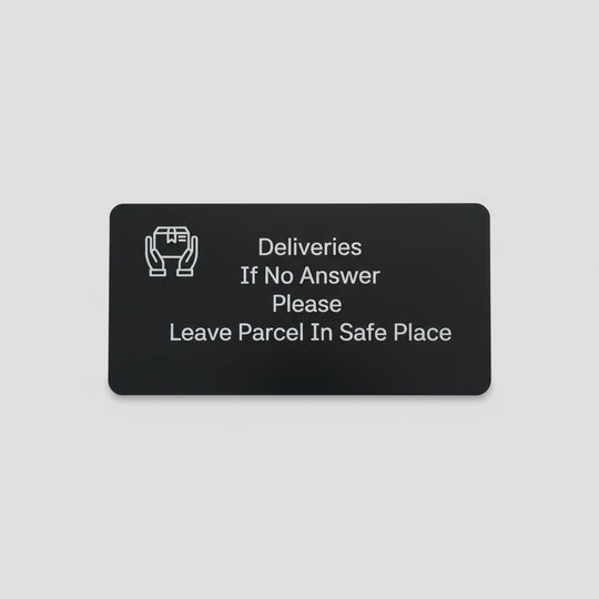 Black card with white text on a wooden surface