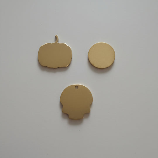 Three gold shapes objects on a wooden surface