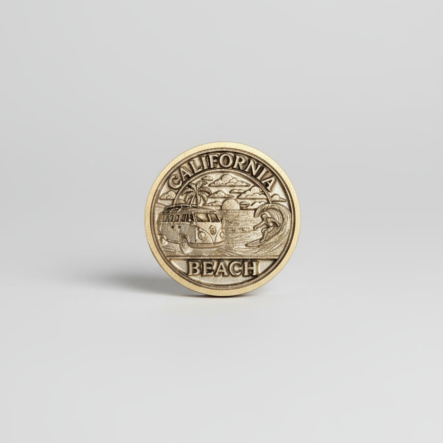 Gold coin with 'California Beach' text on a textured gray surface