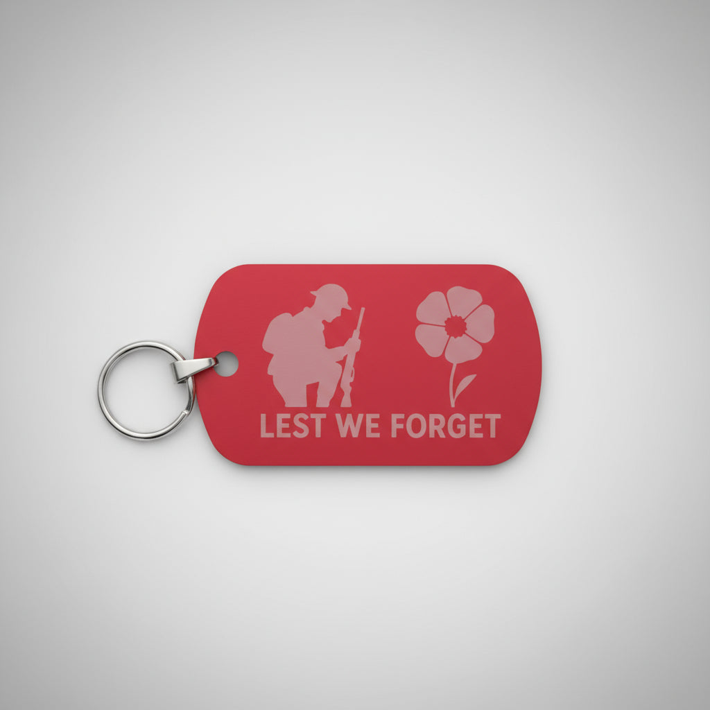 Red keychain tag with 'Lest We Forget' text and a soldier silhouette on a gray textured background