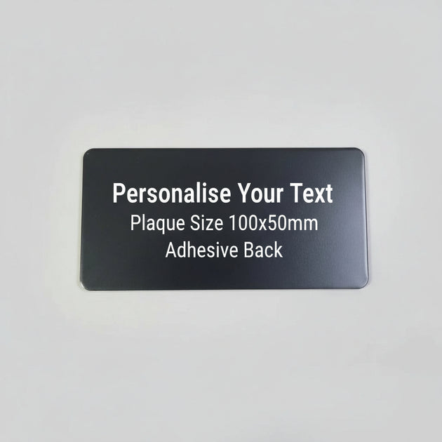 Black rectangular object on a textured gray surface