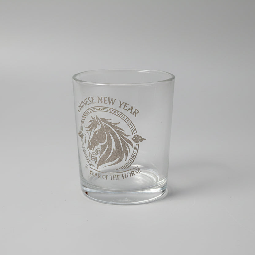 Clear glass with text and design on a textured surface